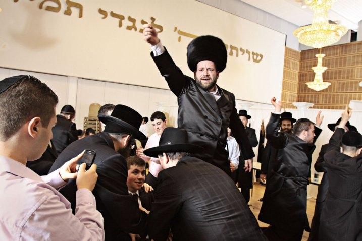 Avi Bresler held aloft at his son's wedding