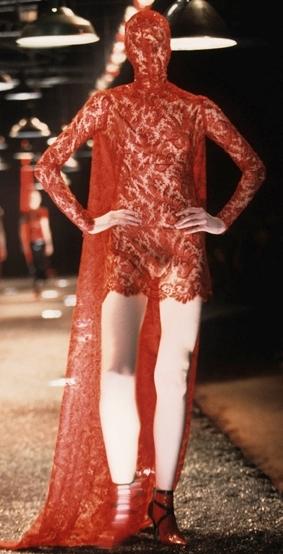 A masked lace dress by the late Alexander McQueen, from 1998, turns the catwalk into pure theatre 